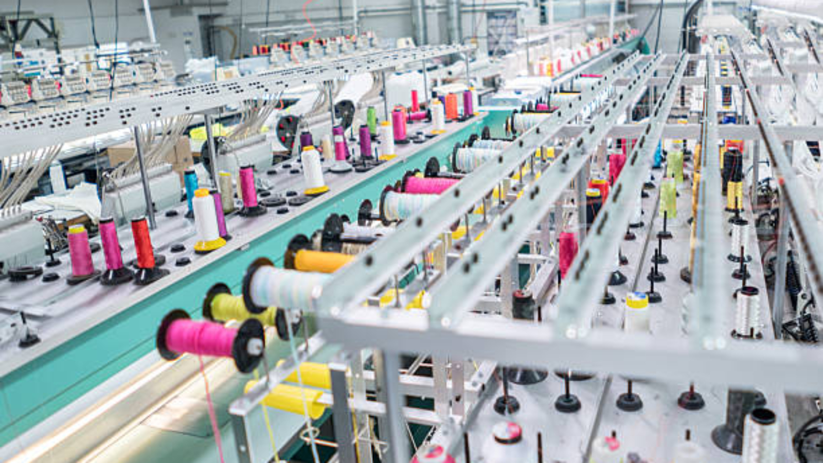 Working embroidery machine at a clothing factory - fashion industry concepts